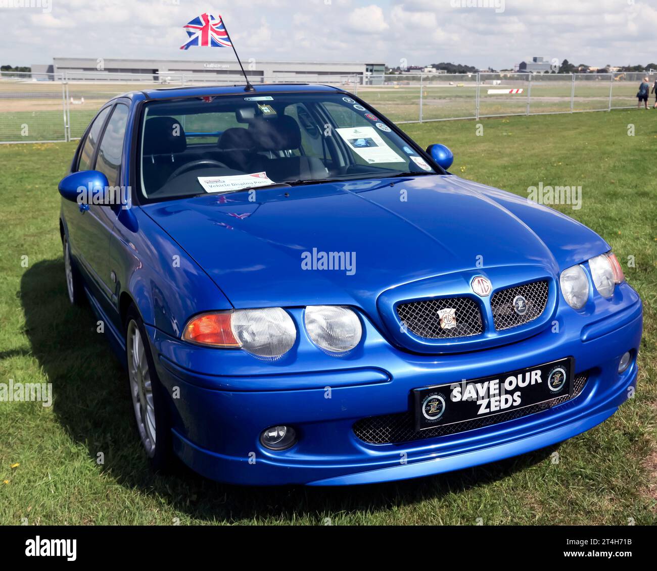 Three-quarter front view of a Blue, 2001, MG ZS, on display at the 2023 British Motor Show, Farnborough Stock Photo