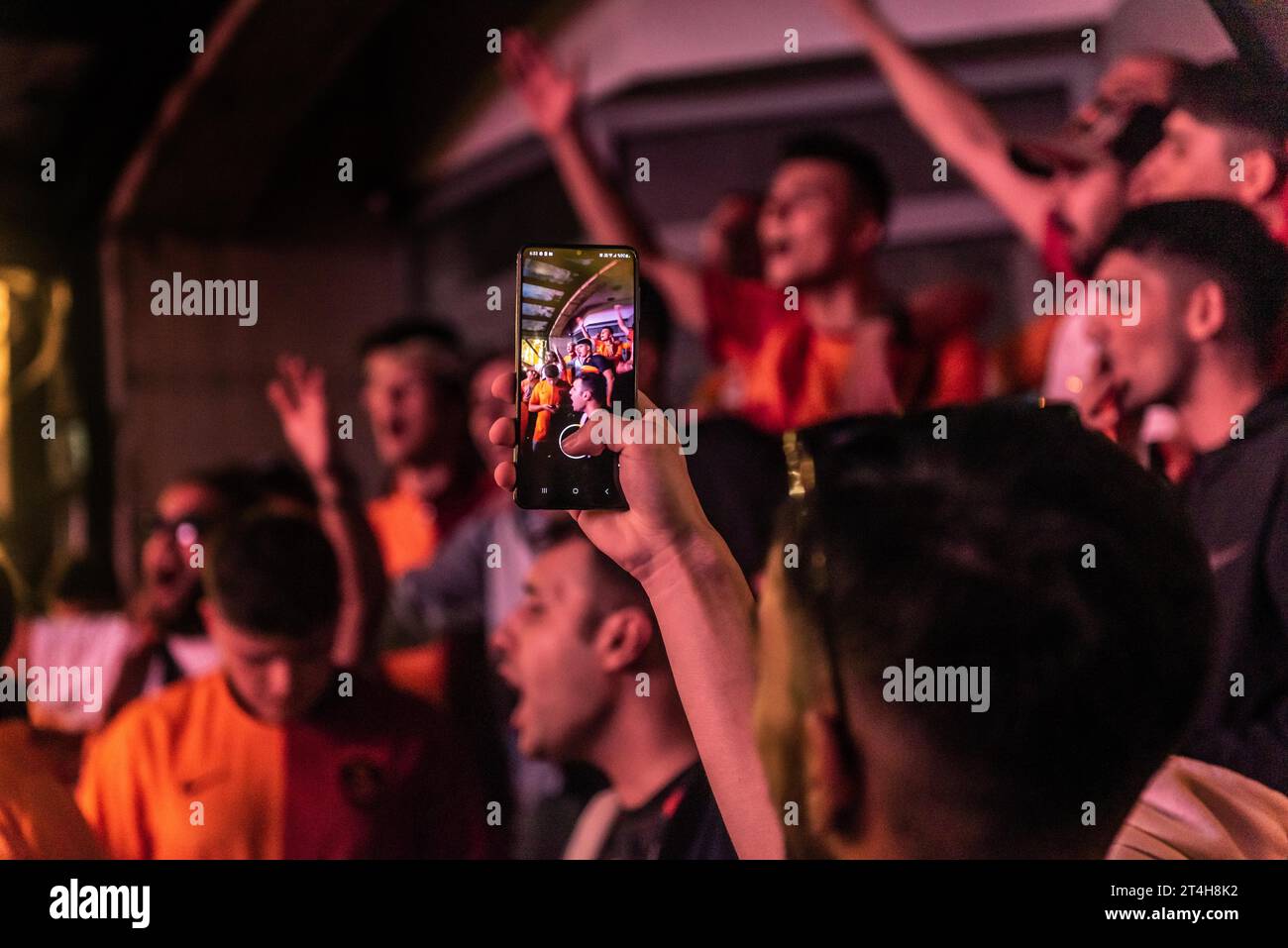 Istanbul, Turkey. October 24th 2023 Galatasaray football fan with a cell phone while chanting songs before the Champions League match against FC Bayer Stock Photo