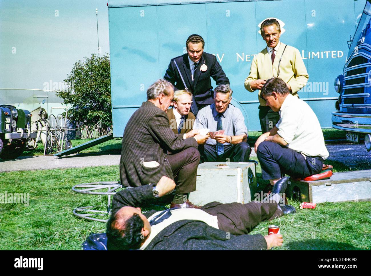 Crew relaxing playing cards, ATV television ITV company outside