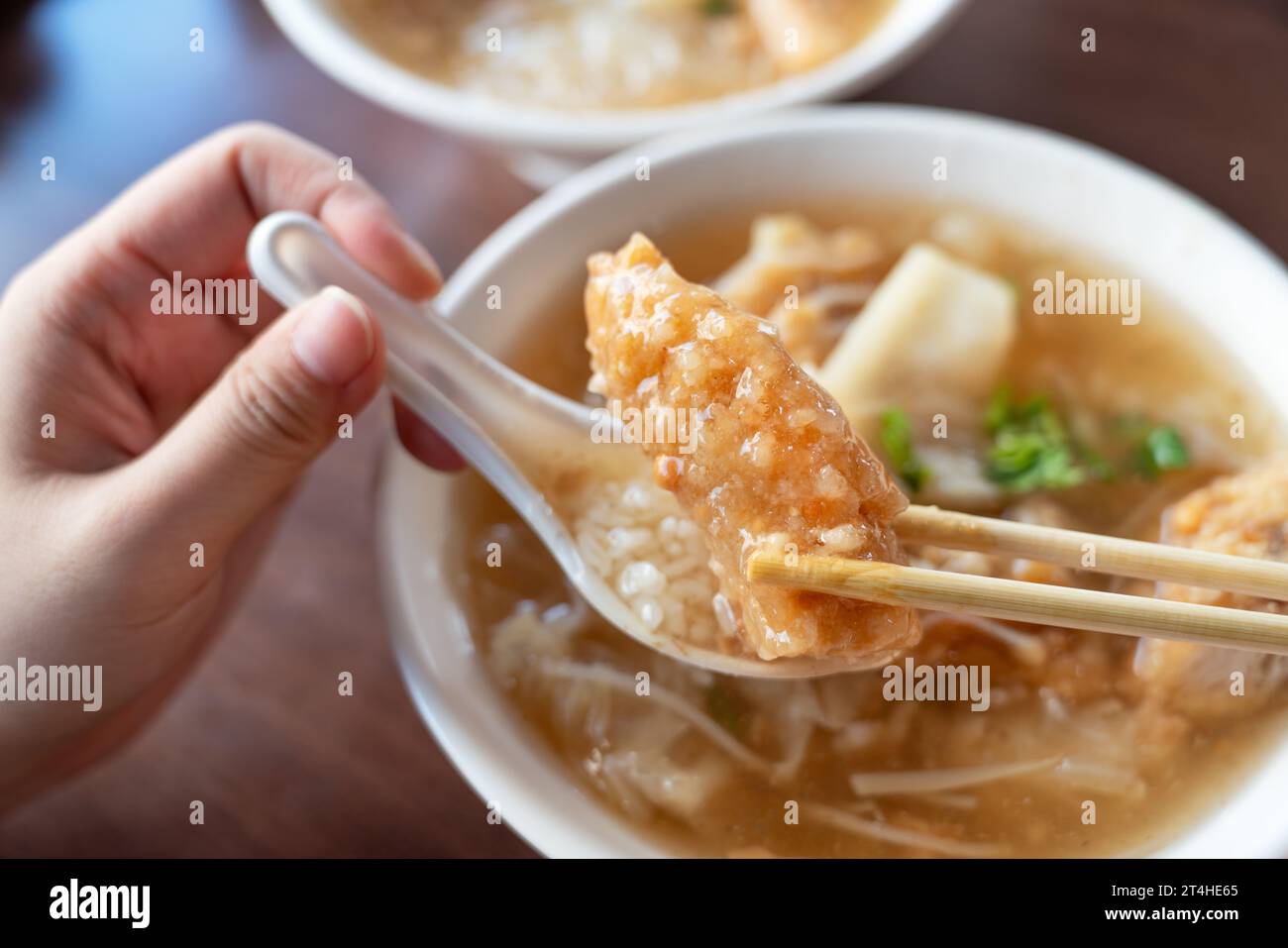Delicious fried narrow-barred Spanish mackerel fish fillet with rice and noodles in thick soup in Tainan, Taiwan. Stock Photo