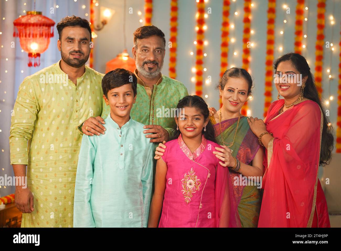 Happy Joint family with traditional attire posing to camera during