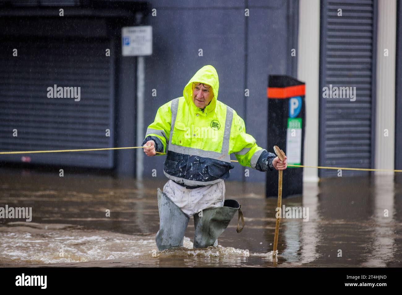 Gerry Peers uses a guide rope to cross through flood water on Bank ...
