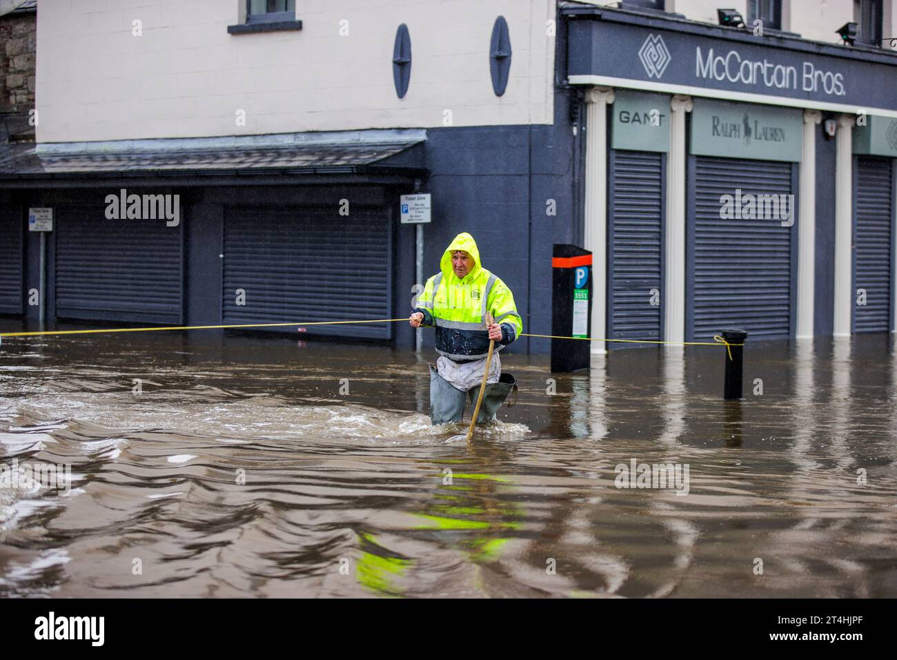 Gerry Peers uses a guide rope to cross through flood water on Bank ...