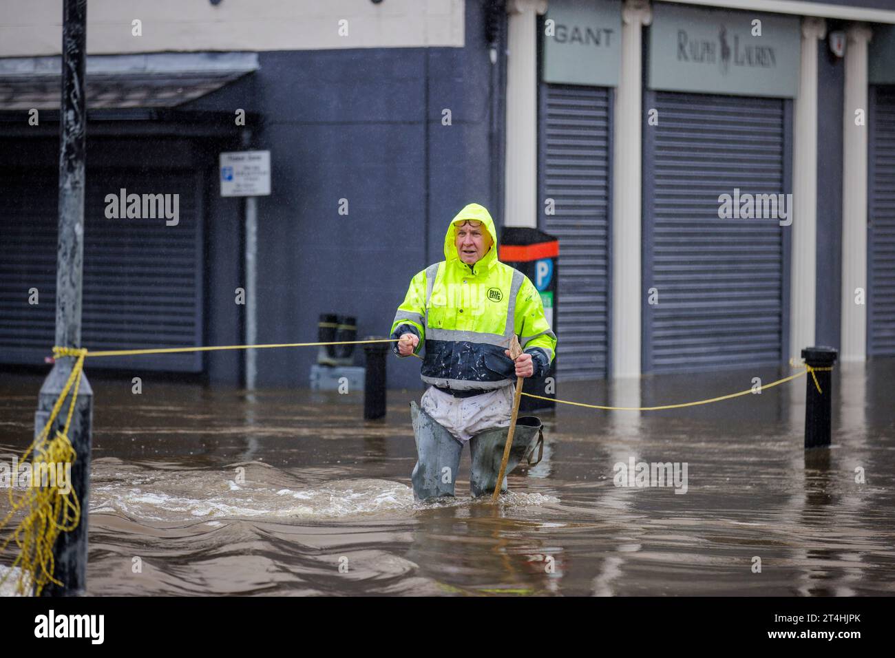 Gerry Peers uses a guide rope to cross through flood water on Bank