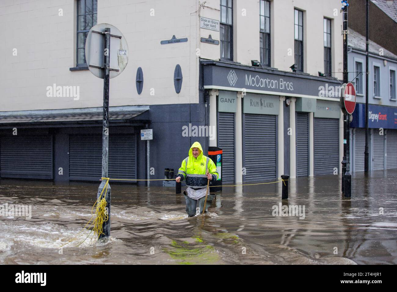 Gerry Peers uses a guide rope to cross through flood water on Bank 