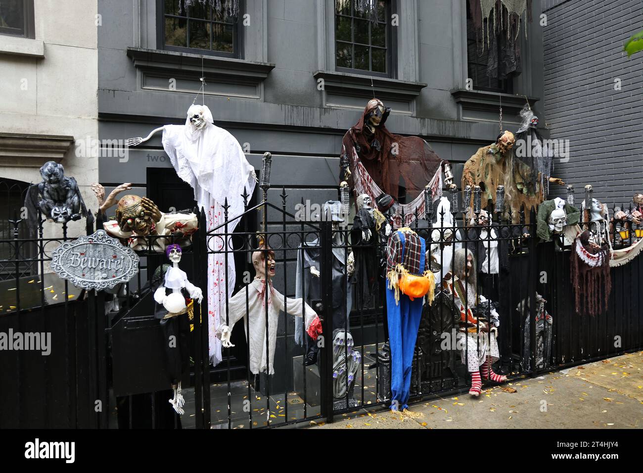 Frightening Halloween decorations cover the exterior of an Upper East