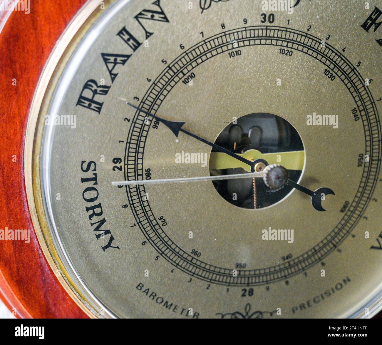 A weather forecasting barometer with the arrow pointing towards Rain UK Stock Photo