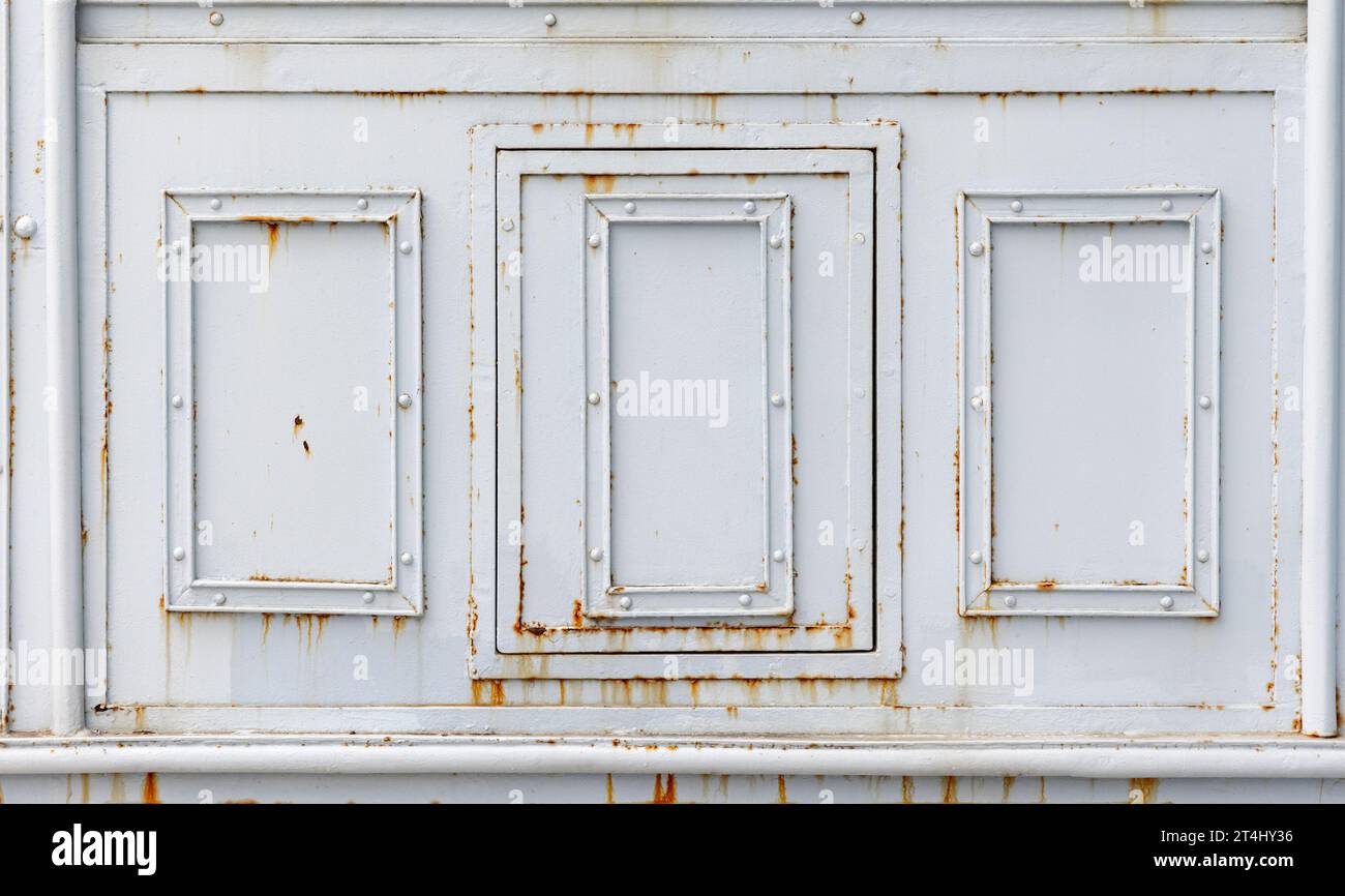 Forged decor with rectangle frames  on a white steel wall, front view, background photo texture Stock Photo