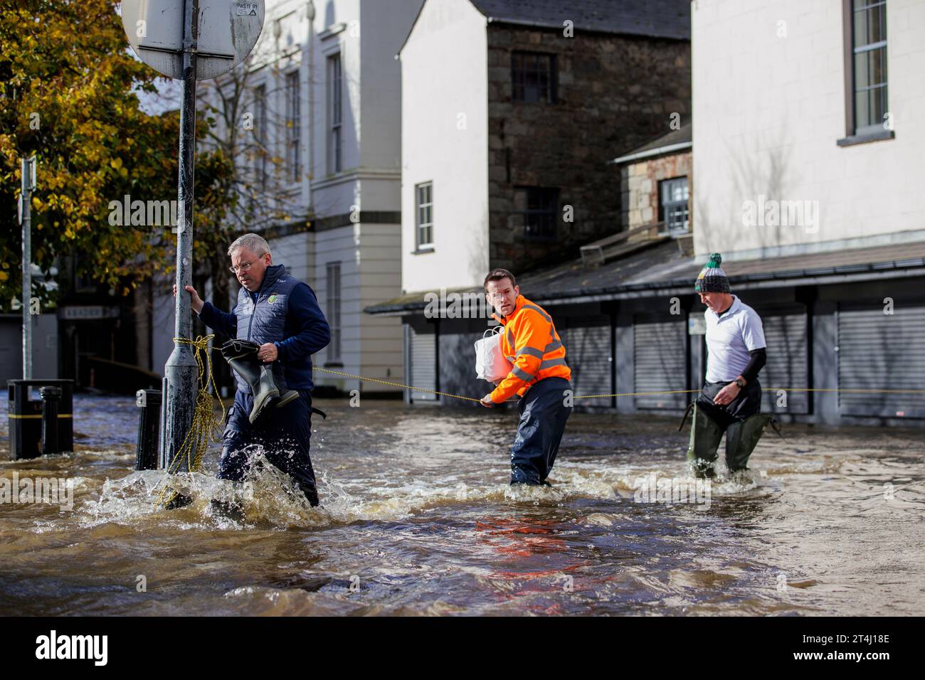People walk through flood water on Bank Parade in Newry Town, Co Down