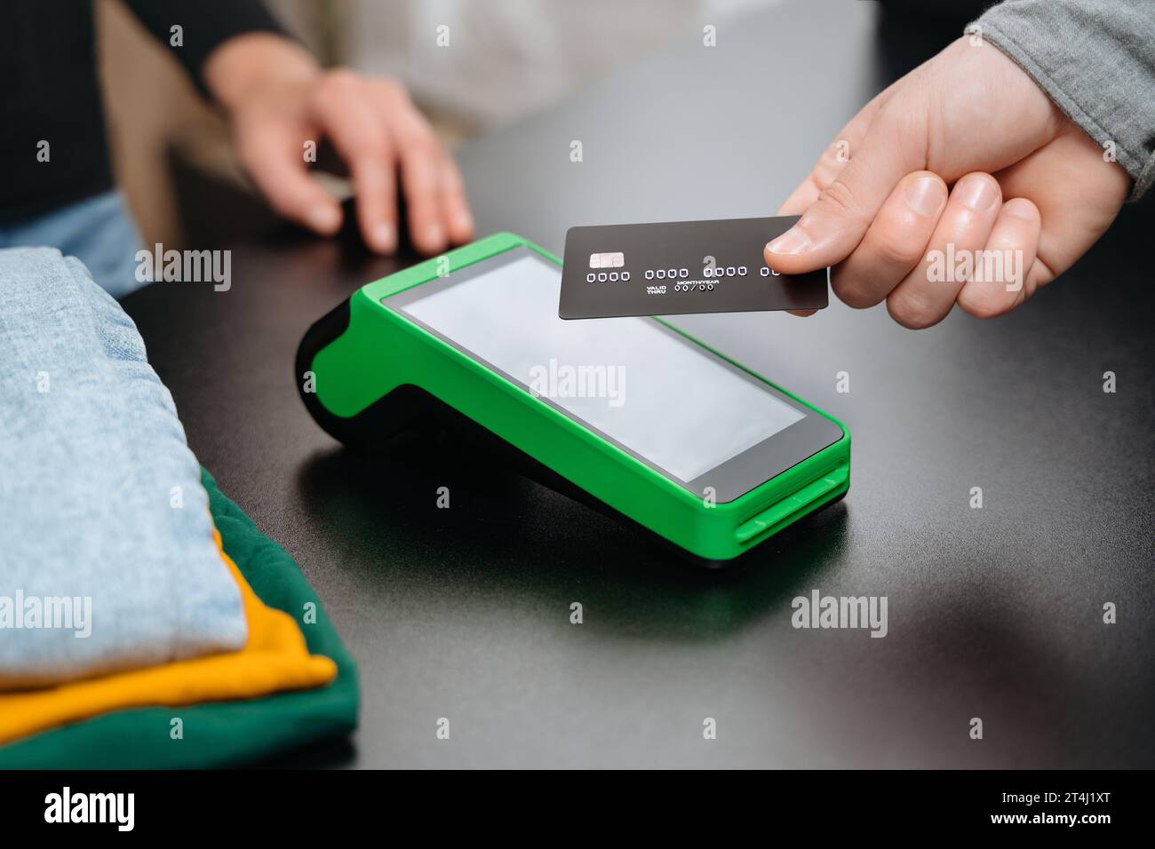 Closeup view, male customer using bank credit card for contactless