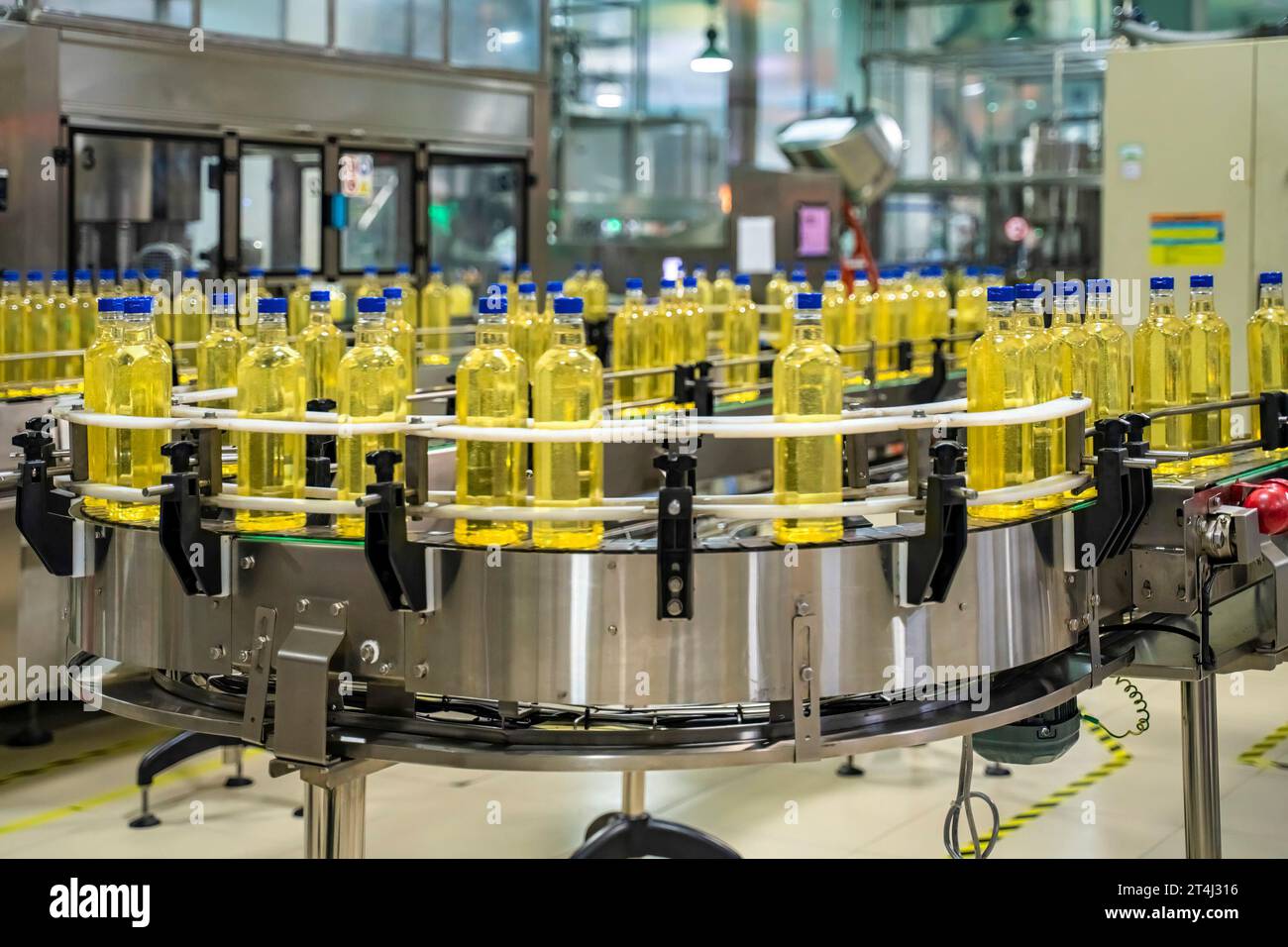 Cooking oil or Sunflower oil in the bottle moving on production line, factory in Ho Chi Minh city, Vietnam Stock Photo