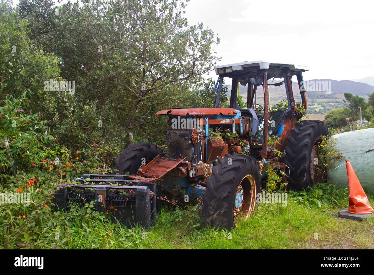 Old rusty defective tractor in a farmyard Stock Photo