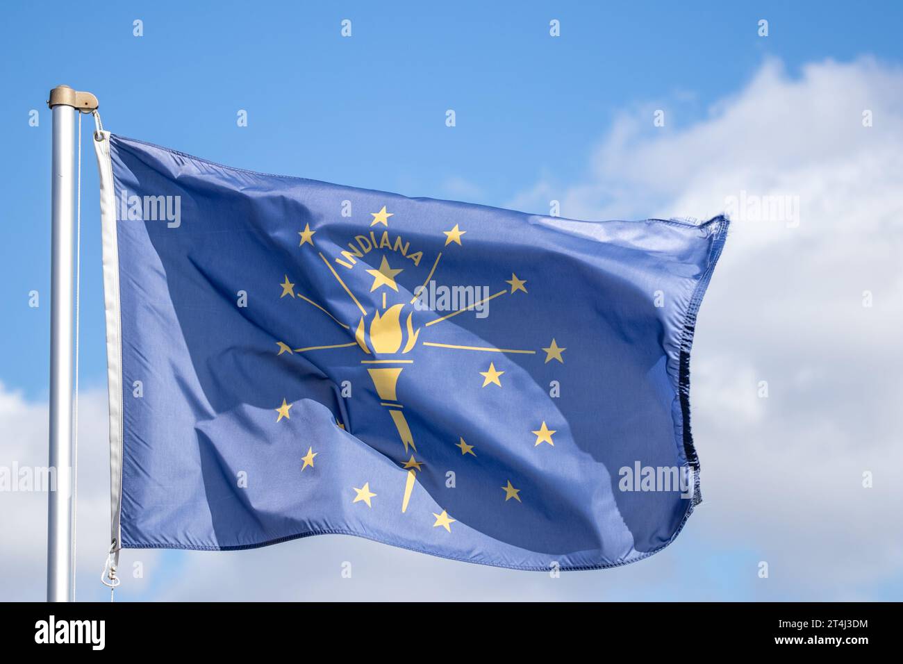 Indiana state flag flying in the wind against blue sky Stock Photo