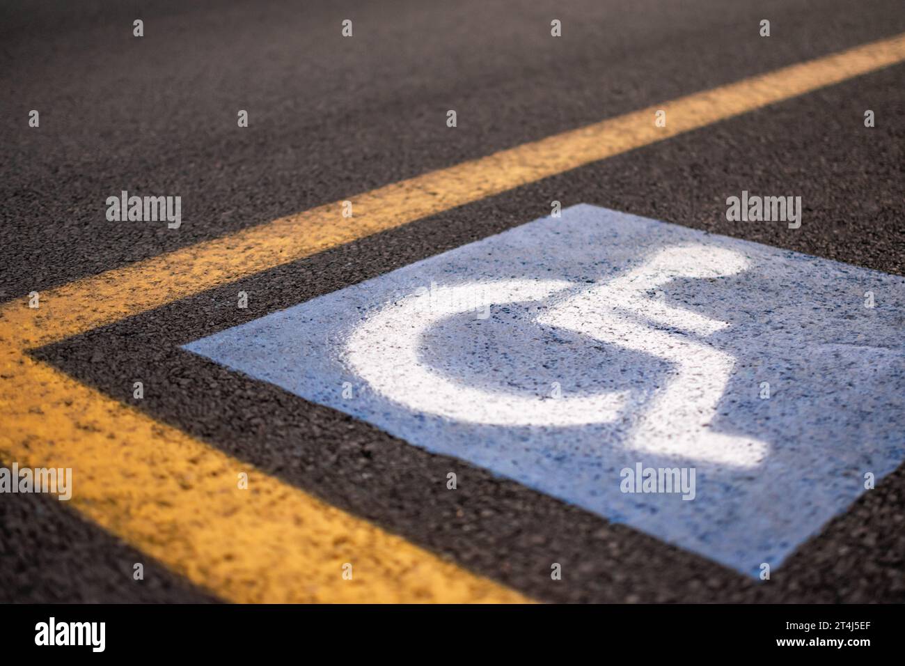 Parking sign for disabled on asphalt with yellow lines Stock Photo Alamy