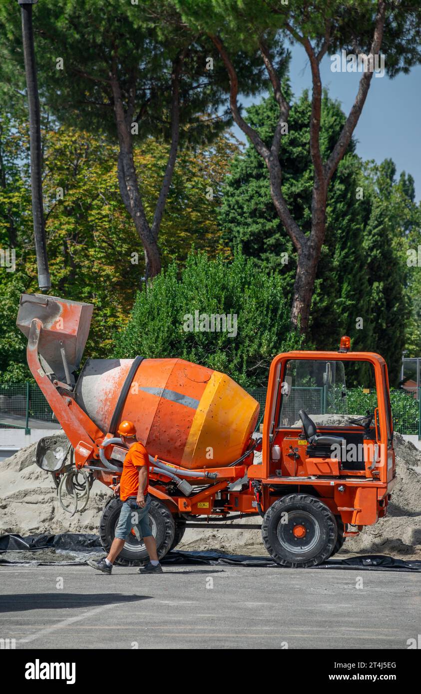 Small Cement truck transporting and turning dry cement by skilled operator Stock Photo