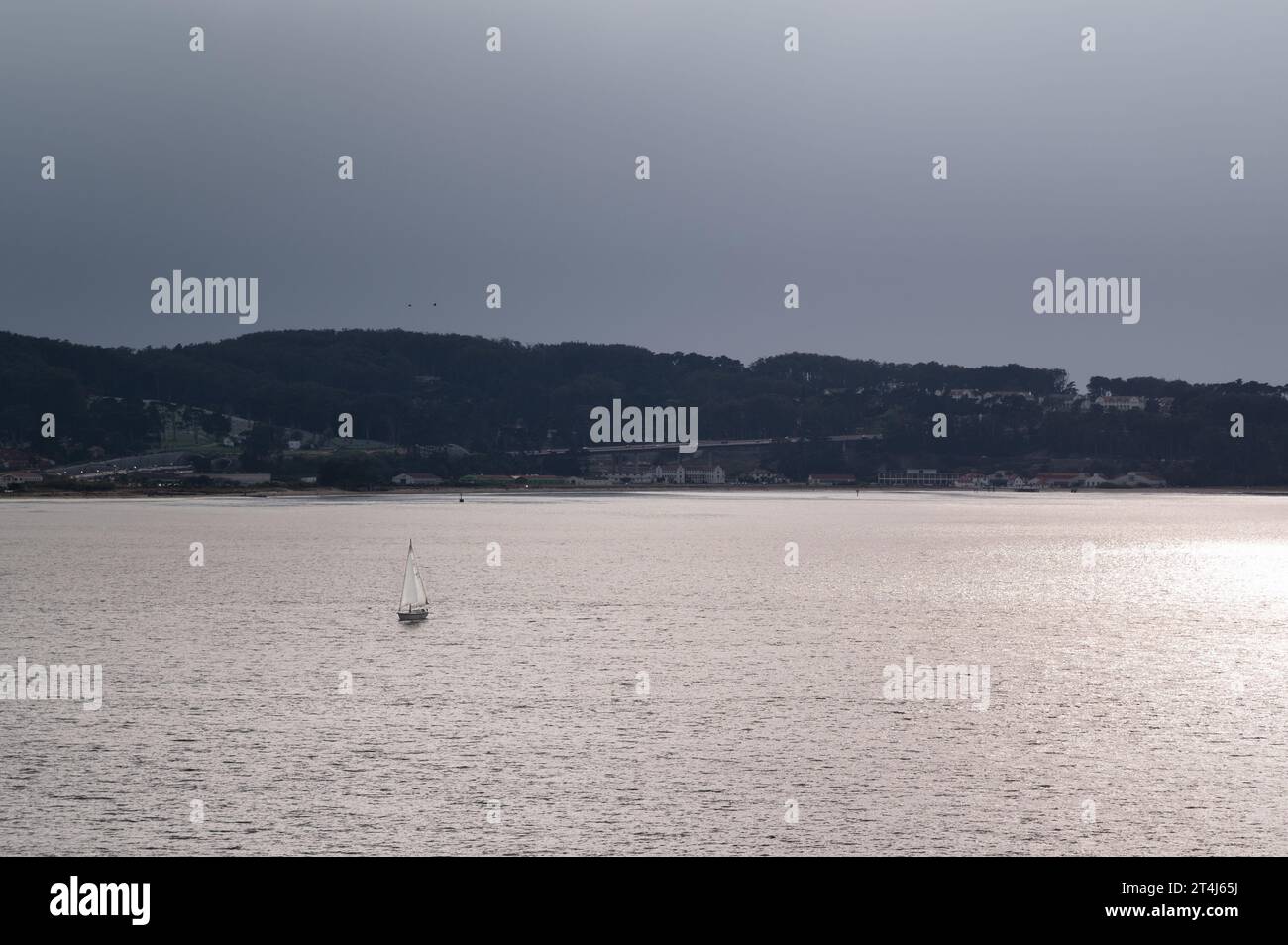 A sailboat in the San Francisco Bay at sunset Stock Photo