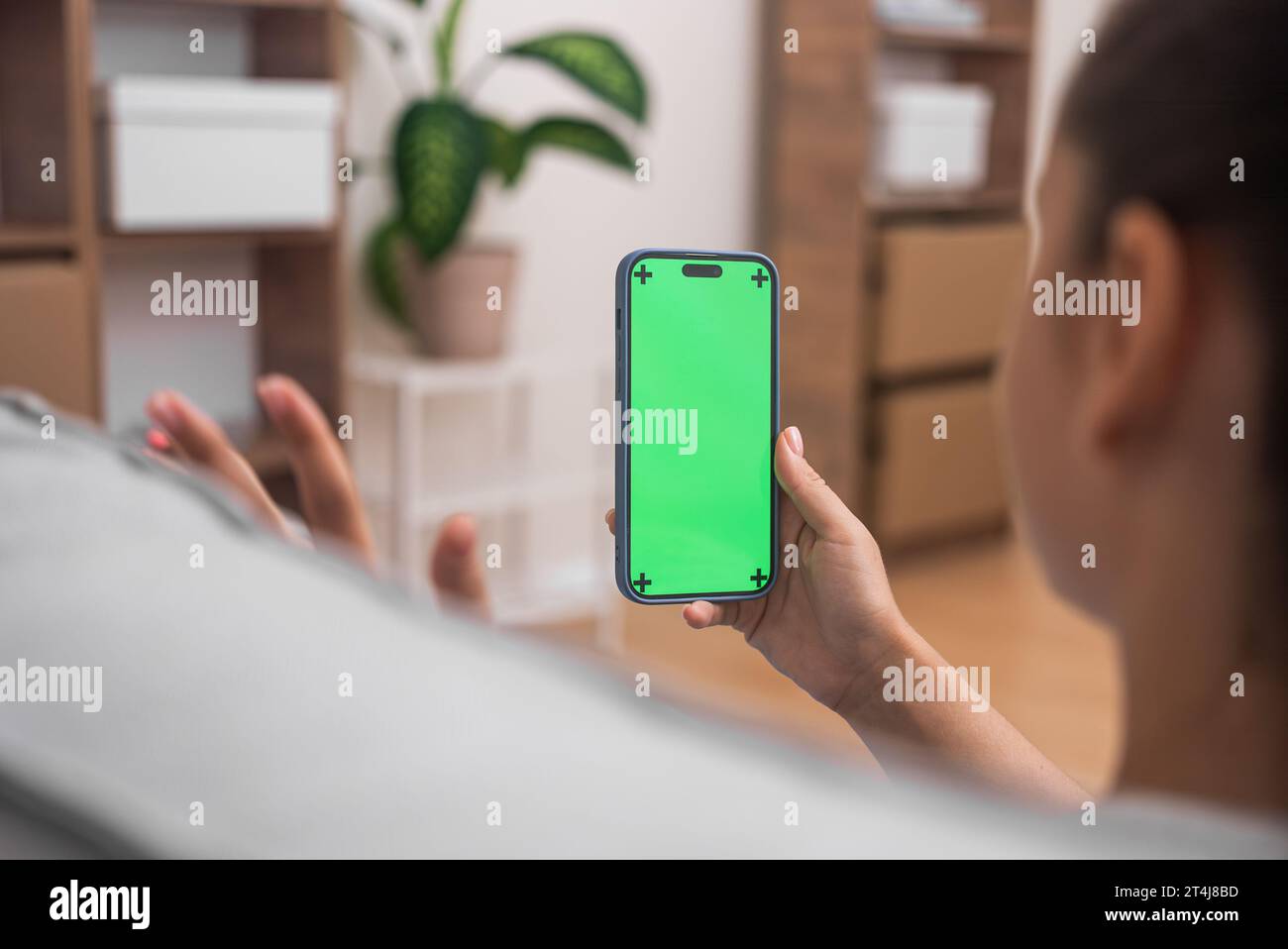woman online call with doctor on smartphone chroma key screen, waving hand, online at home Stock Photo