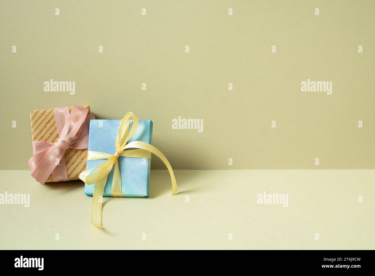 Two gift boxes on table. khaki beige background Stock Photo