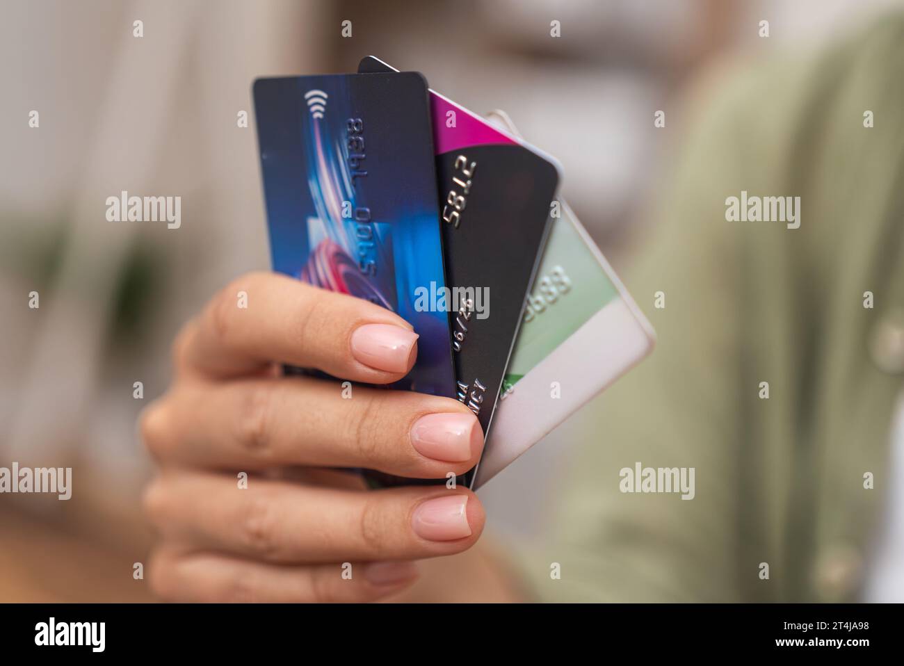 hand holds a stack of credit cards, representing online payments, bank ...