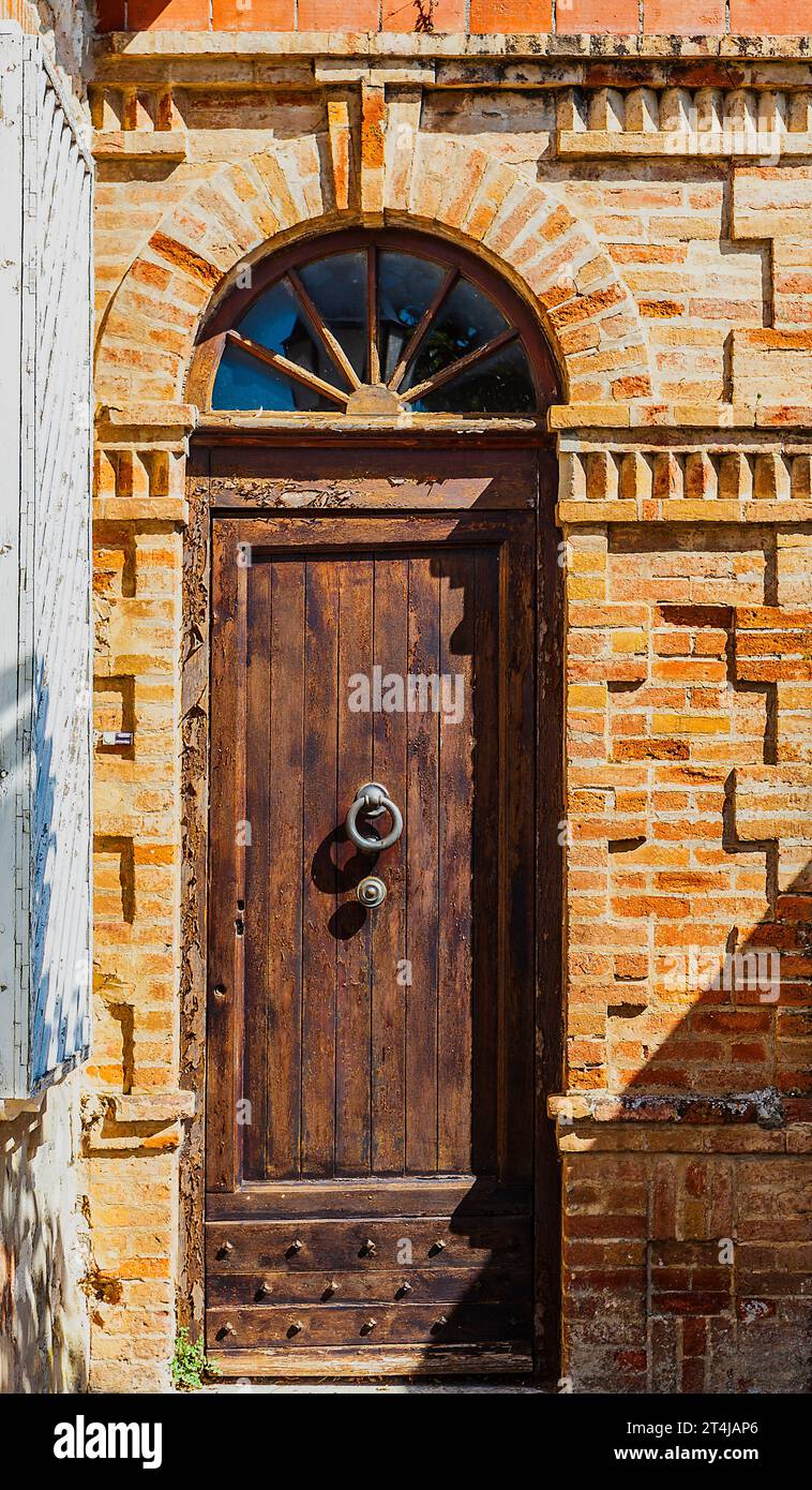 A beautiful door surrounded by an artistic brick design in the heart of Le Castellet, France. Stock Photo