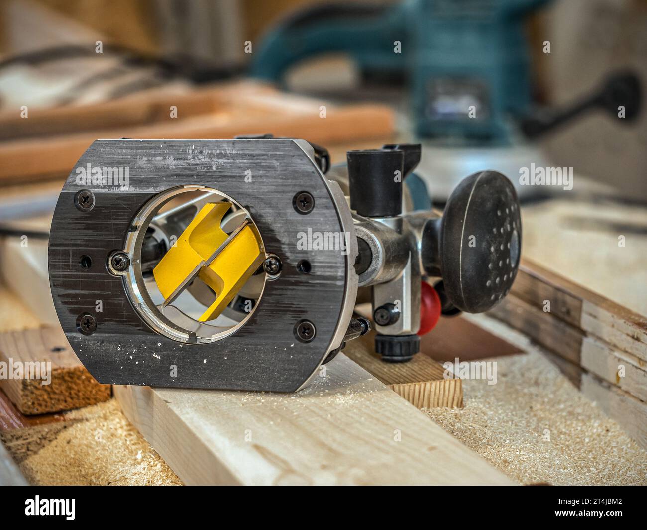 Image of a router with a planing bit placed on planed plank Stock Photo