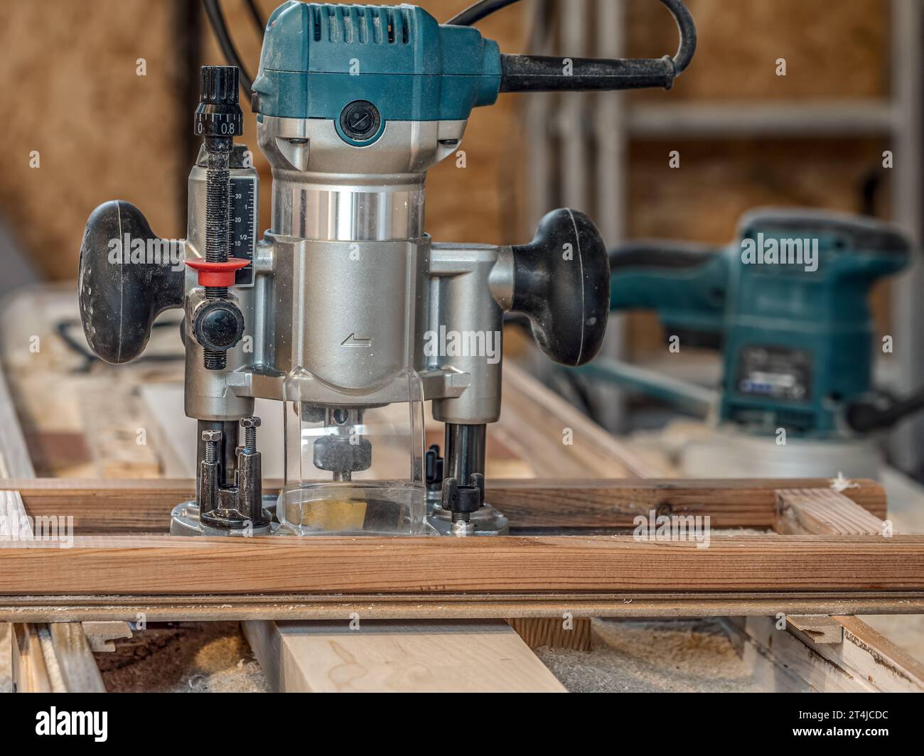 Router with planing bit and planing jig over plank being planed Stock