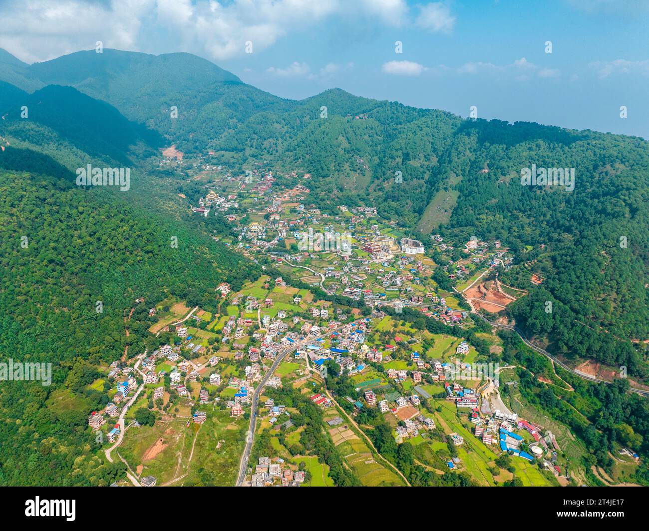 Aerial view of Kathmandu valley, temple on the hills. The monastery is surrounded by lush green hills. Rinpoche Statue, Asura Cave, Old Dashinkali Stock Photo
