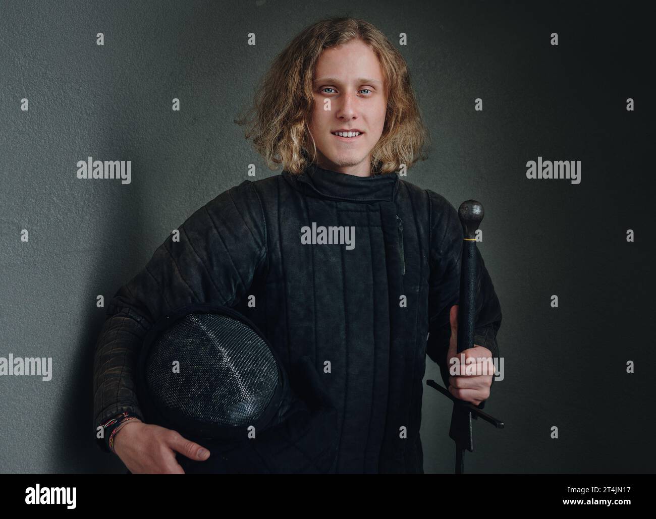 Portrait of a smiling longhaired young teen dressed in black