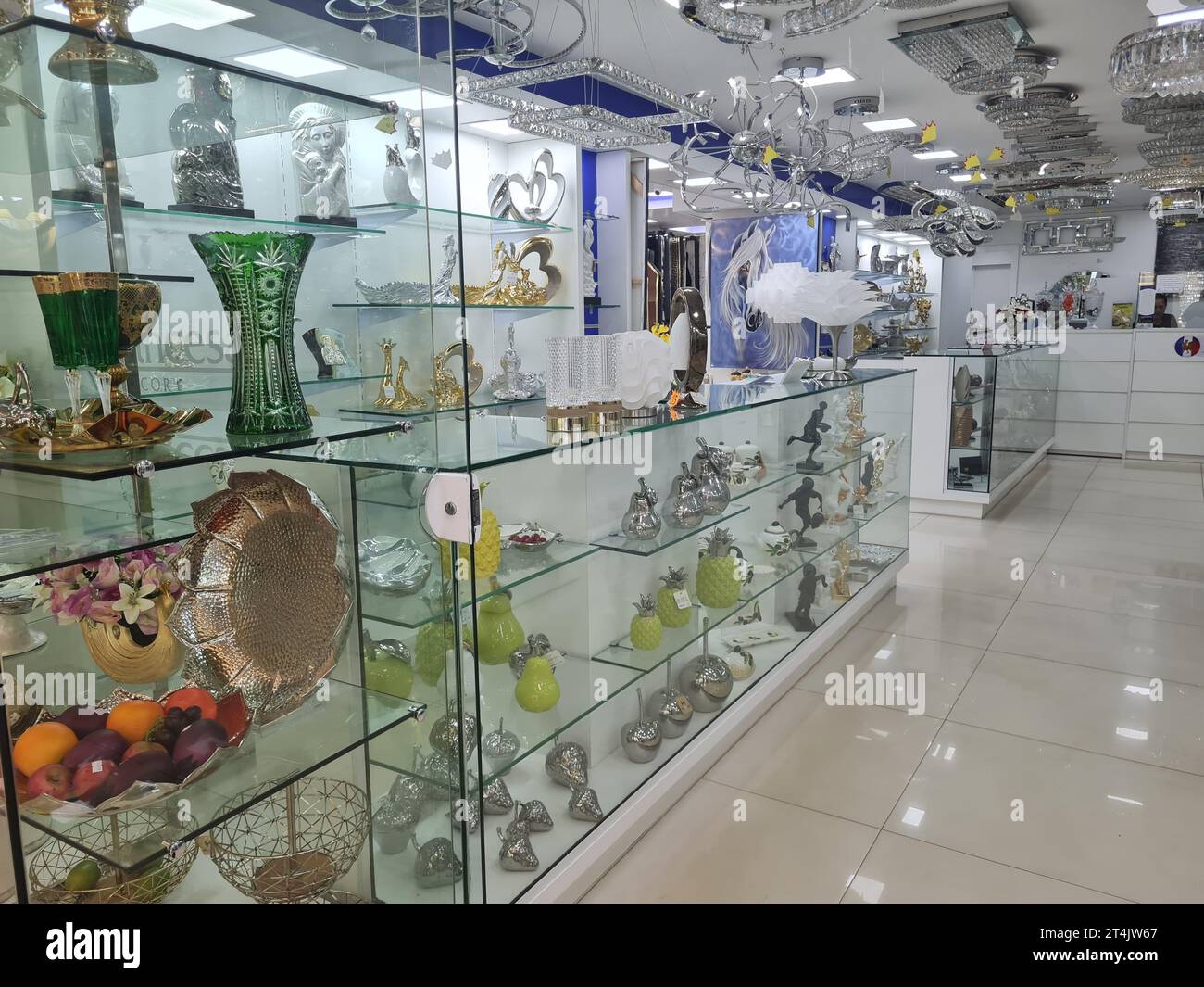 Store shelf with display of various glass items, jars, decorative bottles and sideboards Stock