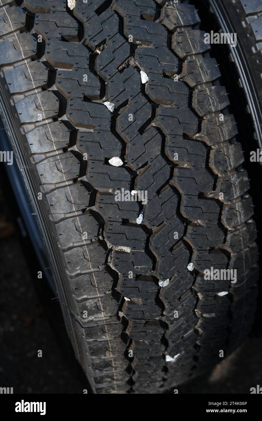 Small stones caught in the tread of truck tyre which can cause a danger ...