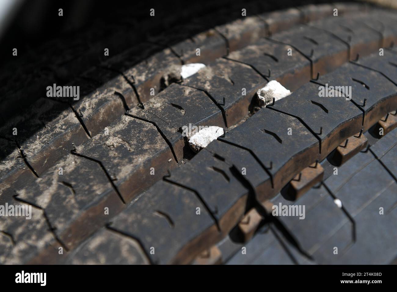 Small stones caught in the tread of truck tyre which can cause a danger to other motorists flying out at speed. Stock Photo