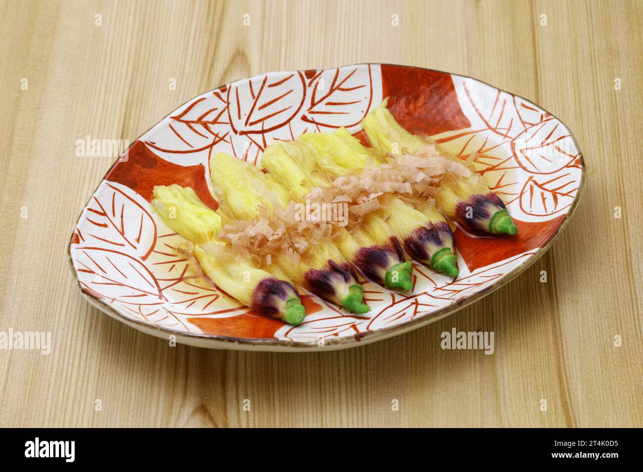 edible okra flowers soaking in dashi stock and sprinkled with bonito flakes, Japanese cuisine Stock Photo