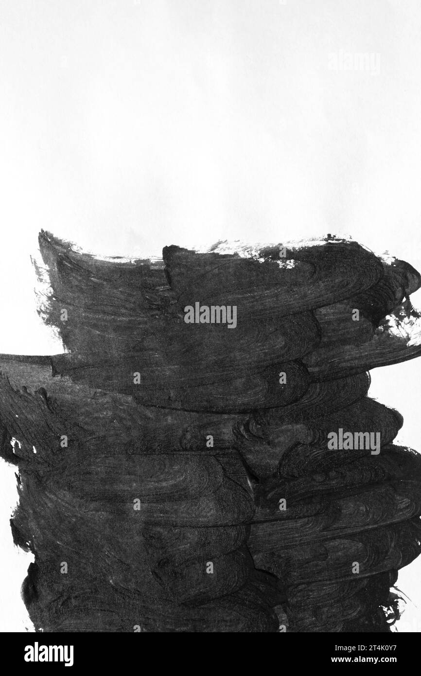 Abstract brush strokes of black paint on white surface. Smears with ...