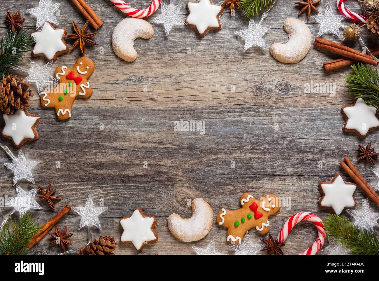 Flour New Year background. Christmas tree branches, gingerbread cookies,  spices and baking supplies on black wood background. Christmas, New Year  gree Stock Photo - Alamy