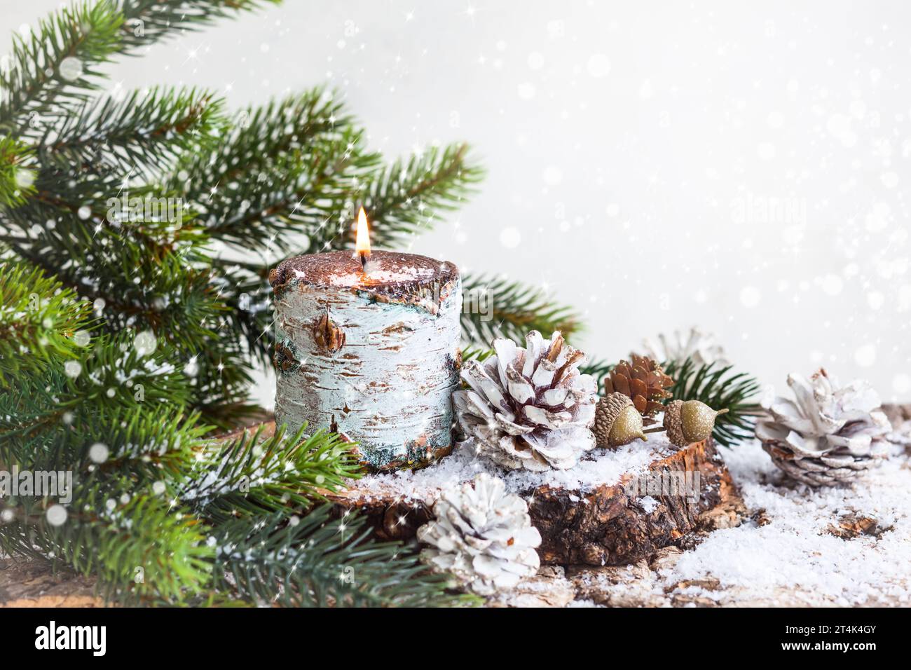 Christmas decoration with burning candle,fir branches and pine cones ...