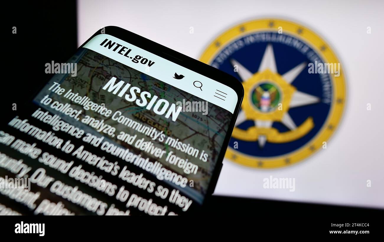 Mobile phone with website of agency group United States Intelligence Community (IC) in front of seal. Focus on top-left of phone display. Stock Photo
