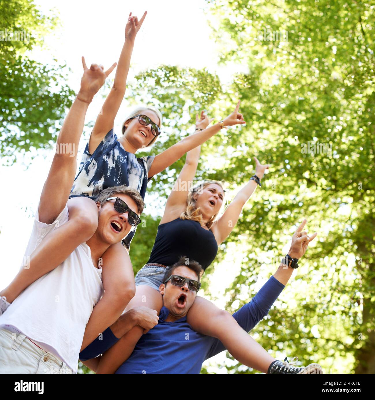 Epic times. Two guys carrying their girlfriends on their shoulders at a