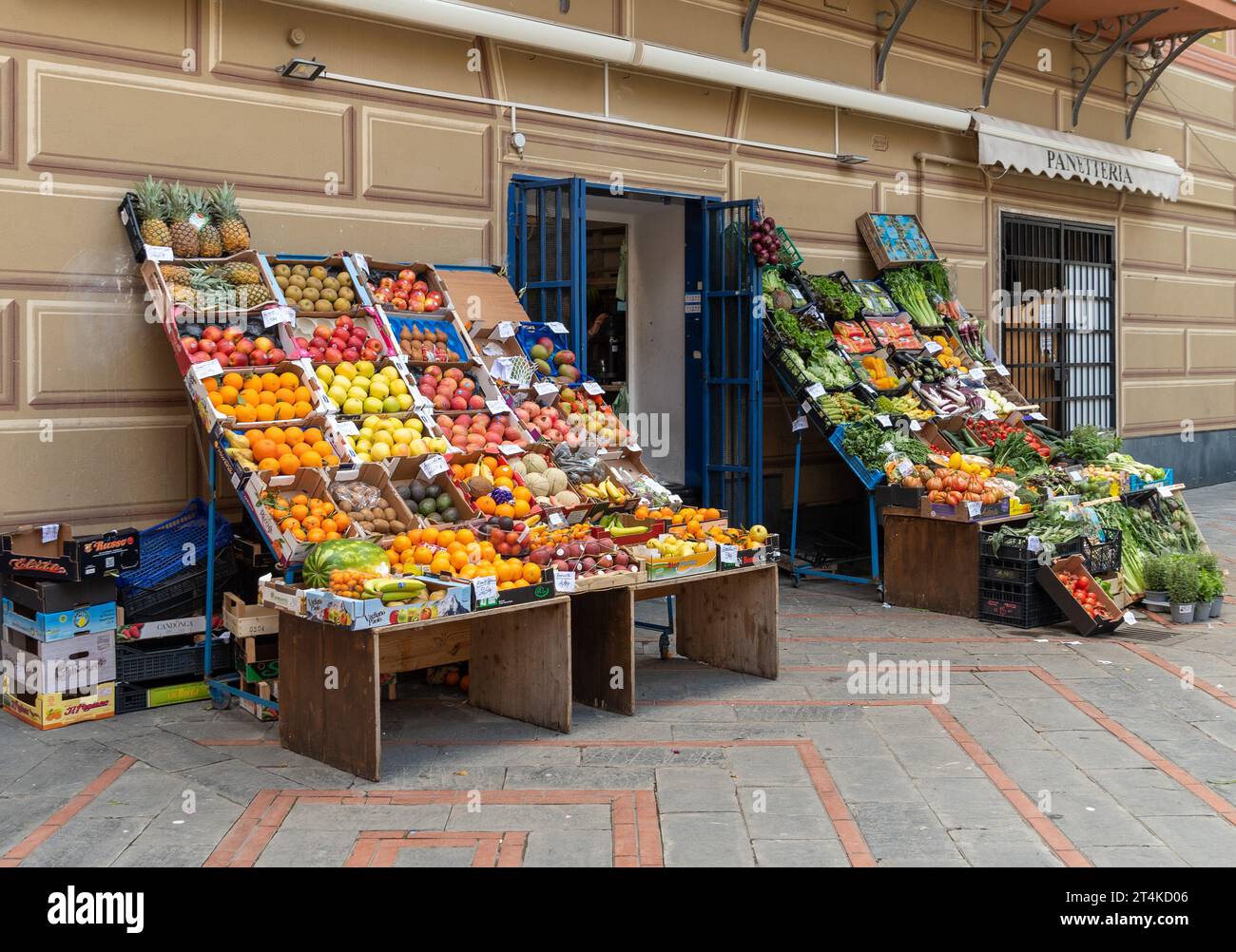 Greengrocer's shop with fruit and vegetables displayed on the sidewalk ...