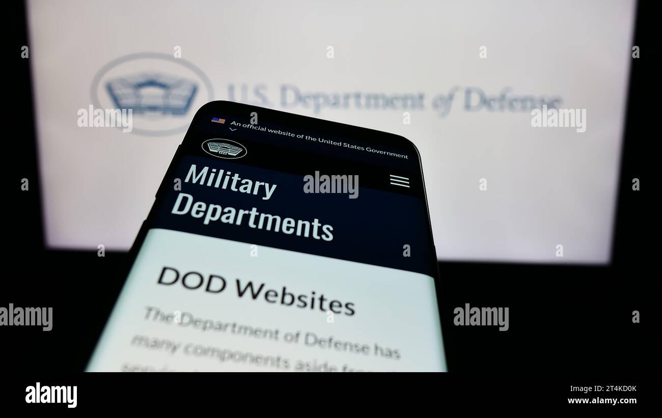 Mobile phone with website of United States Department of Defense (DoD) in front of logo. Focus on top-left of phone display. Stock Photo