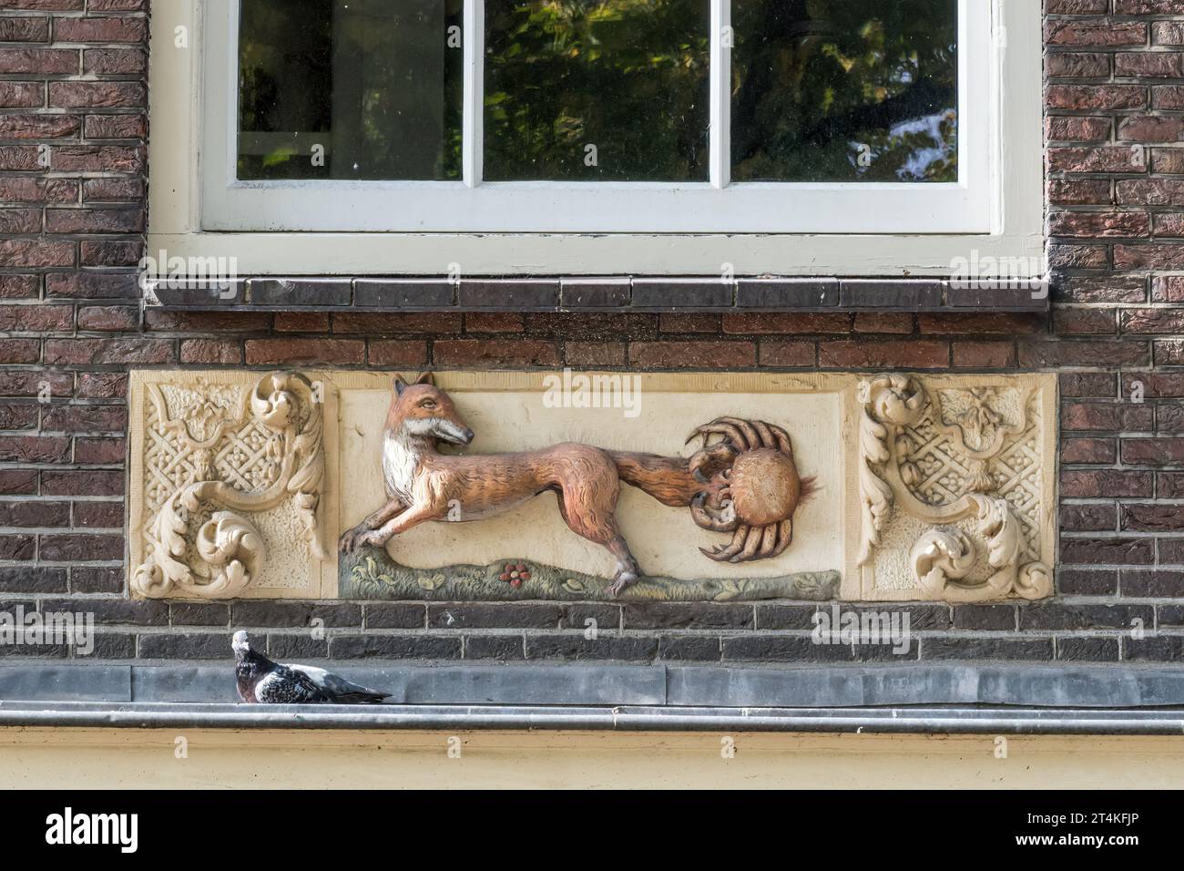 The fox  & crab gable stone on a building in Noordermarkt, Amsterdam, references the Aesops fable. Stock Photo