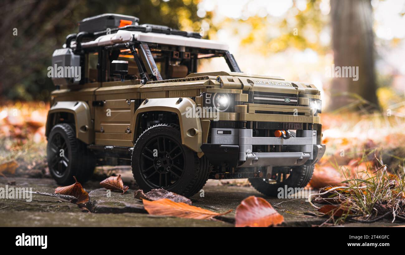 Lego model of an off-road vehicle in the autumn foliage. Last rays of sun before eveningbreak. Dusk, fog is in the air. Stock Photo