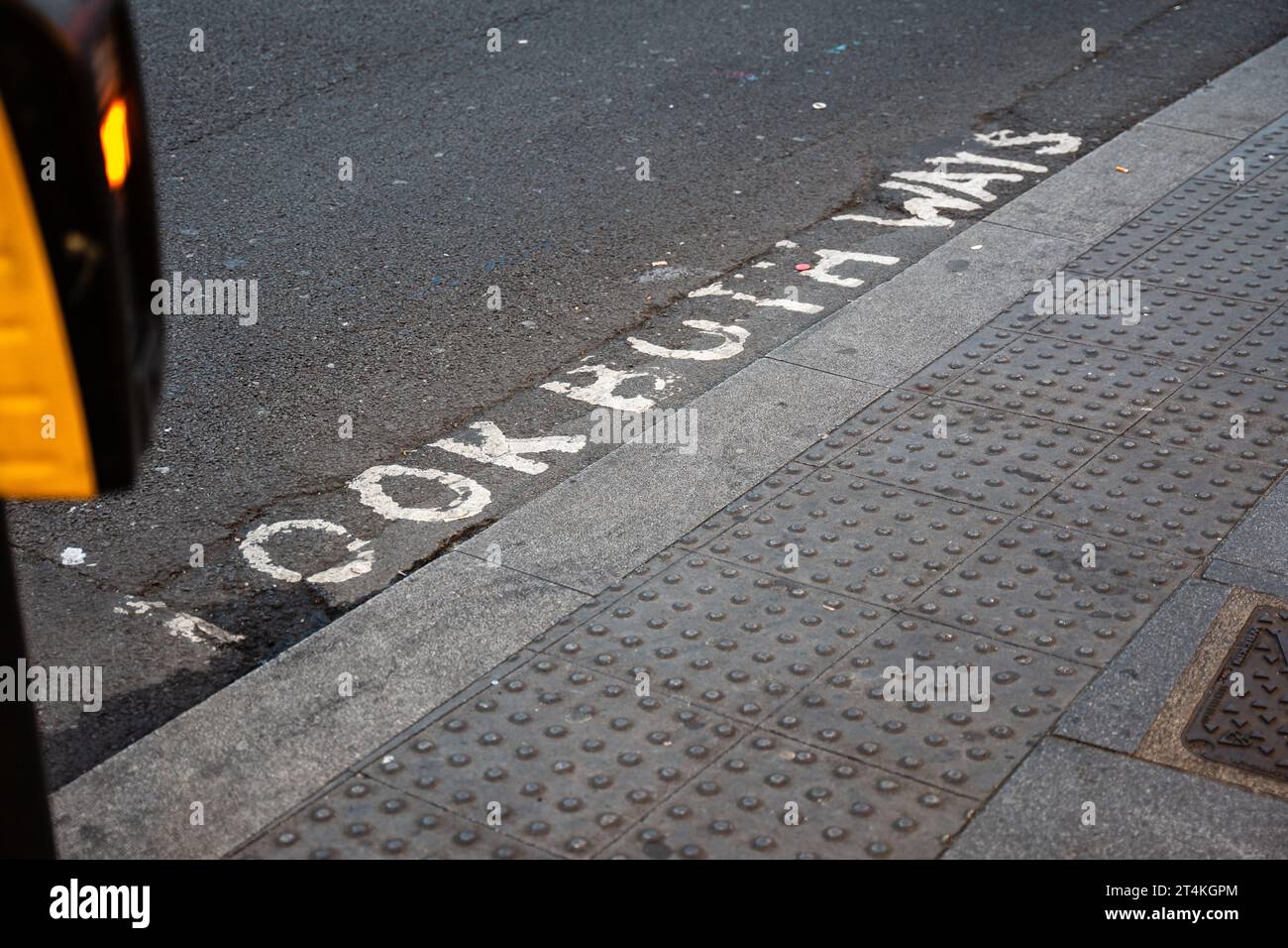 'Look Both Ways' letters are painted on the New Oxford Street. Pedestrian crossing in the London Borough of Camden, UK. Stock Photo