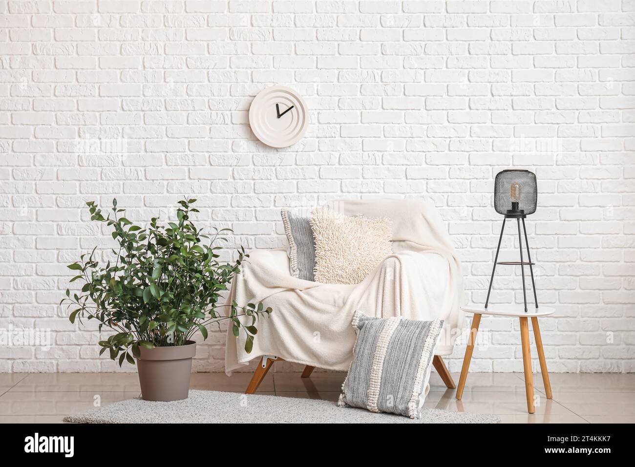 Interior of living room with armchair, lamp and houseplant Stock Photo ...