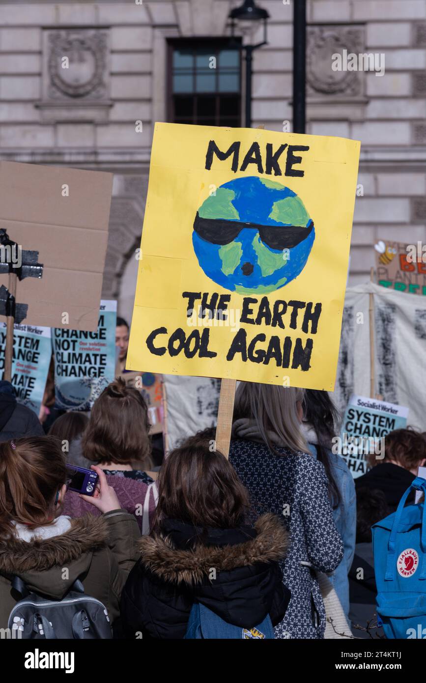 Youngsters at a Youth Strike 4 Climate protest in Parliament Square, London, UK. Children demanding action on global warming. Cool the earth sign Stock Photo