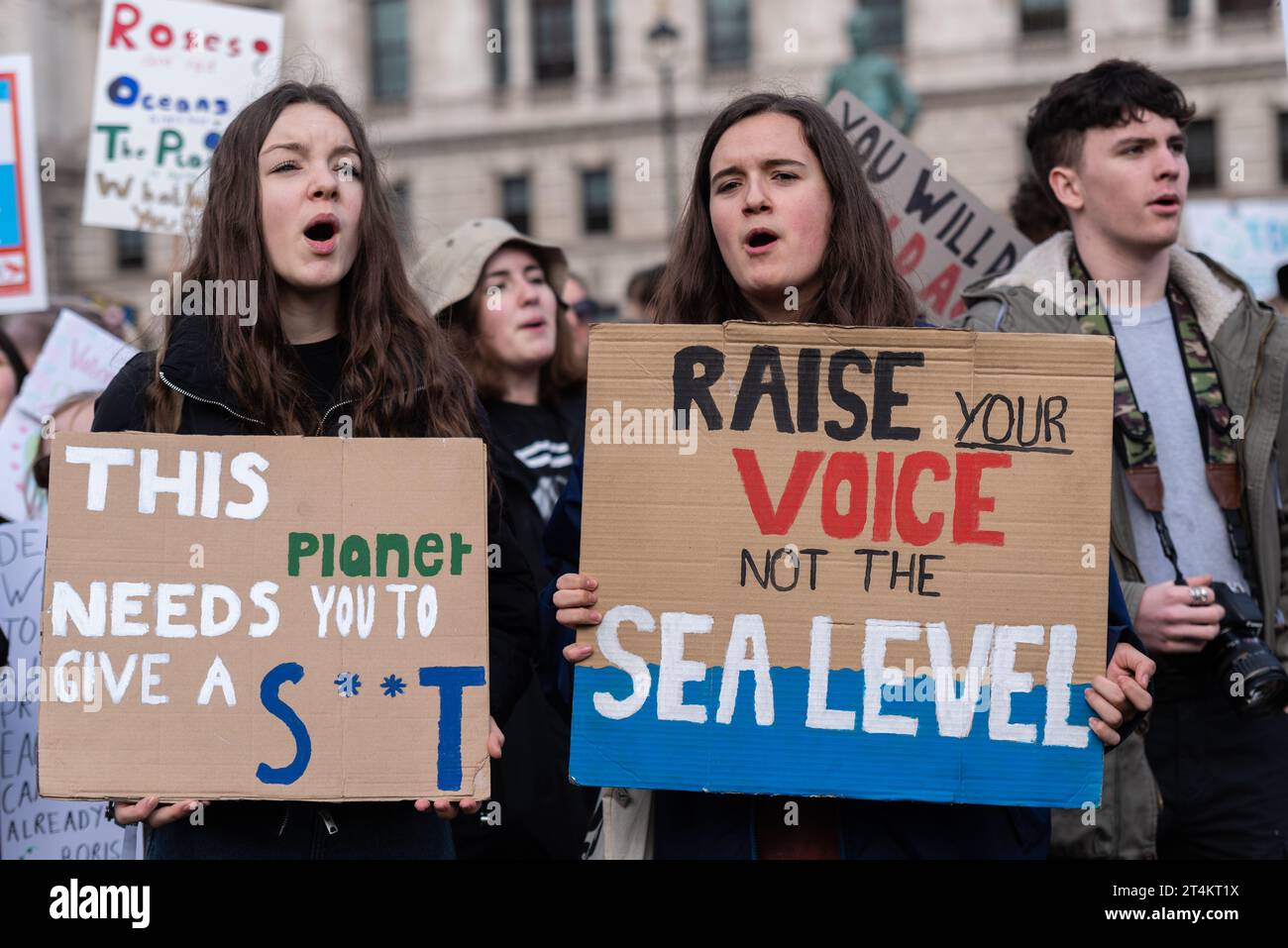 Youngsters at a Youth Strike 4 Climate protest in Parliament Square, London, UK. Children demanding action on global warming. Sea level warning Stock Photo