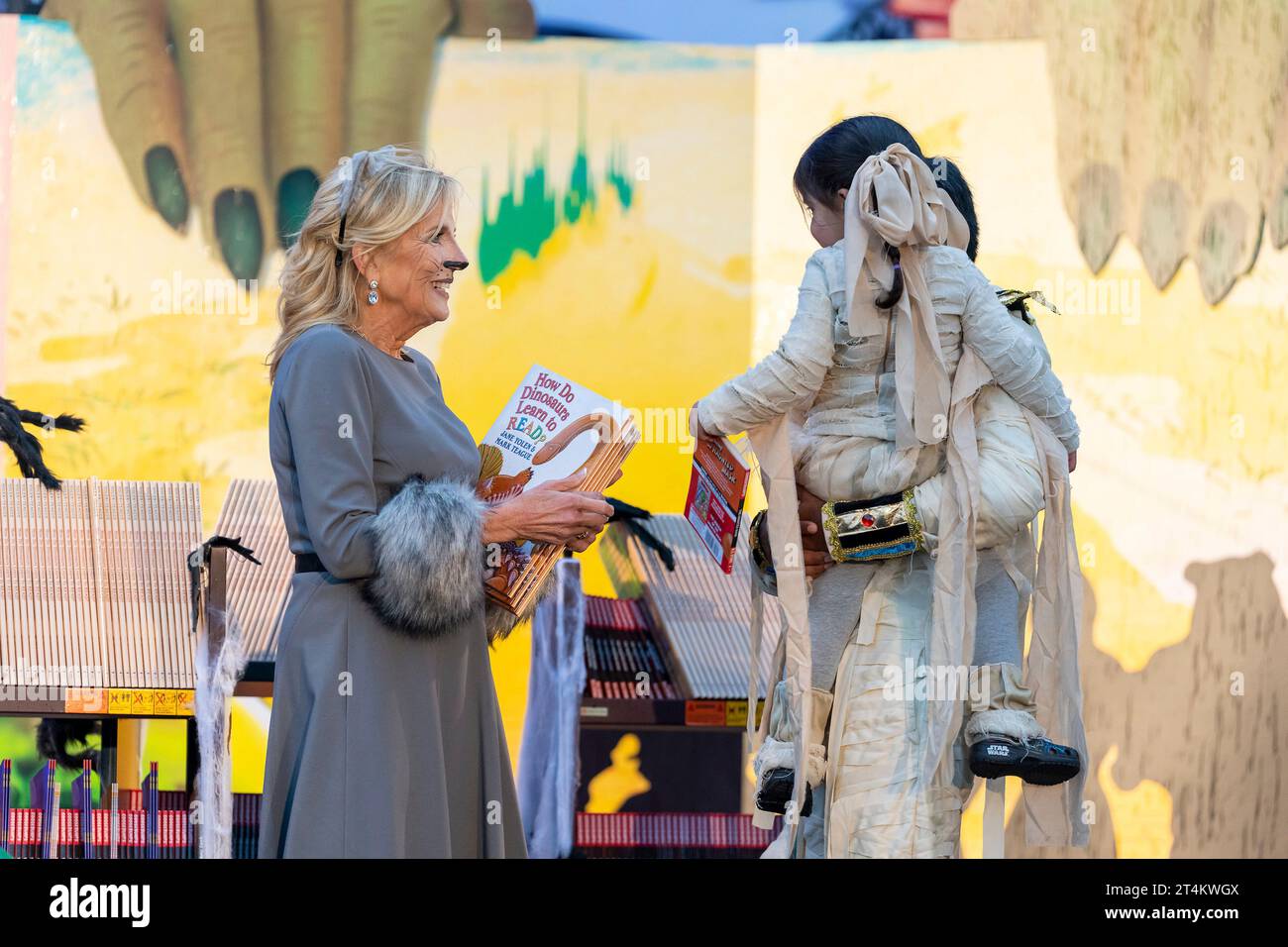 Washington, United States. 30th Oct, 2023. U.S. First Lady Jill Biden hands books to a young, costumed trick or treater during the White House Halloween celebration at the South Portico, October 30, 2023 in Washington, DC Credit: Cameron Smith/White House Photo/Alamy Live News Stock Photo