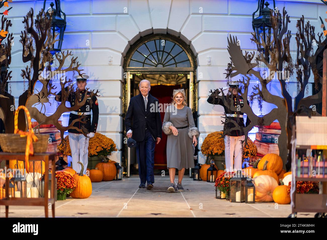 Washington, United States. 30th Oct, 2023. U.S. President Joe Biden, left, and First Lady Jill Biden walk out of the Diplomatic Entrance to welcome costumed trick or treaters during the White House Halloween celebration at the South Portico, October 30, 2023 in Washington, DC Credit: Adam Schultz/White House Photo/Alamy Live News Stock Photo