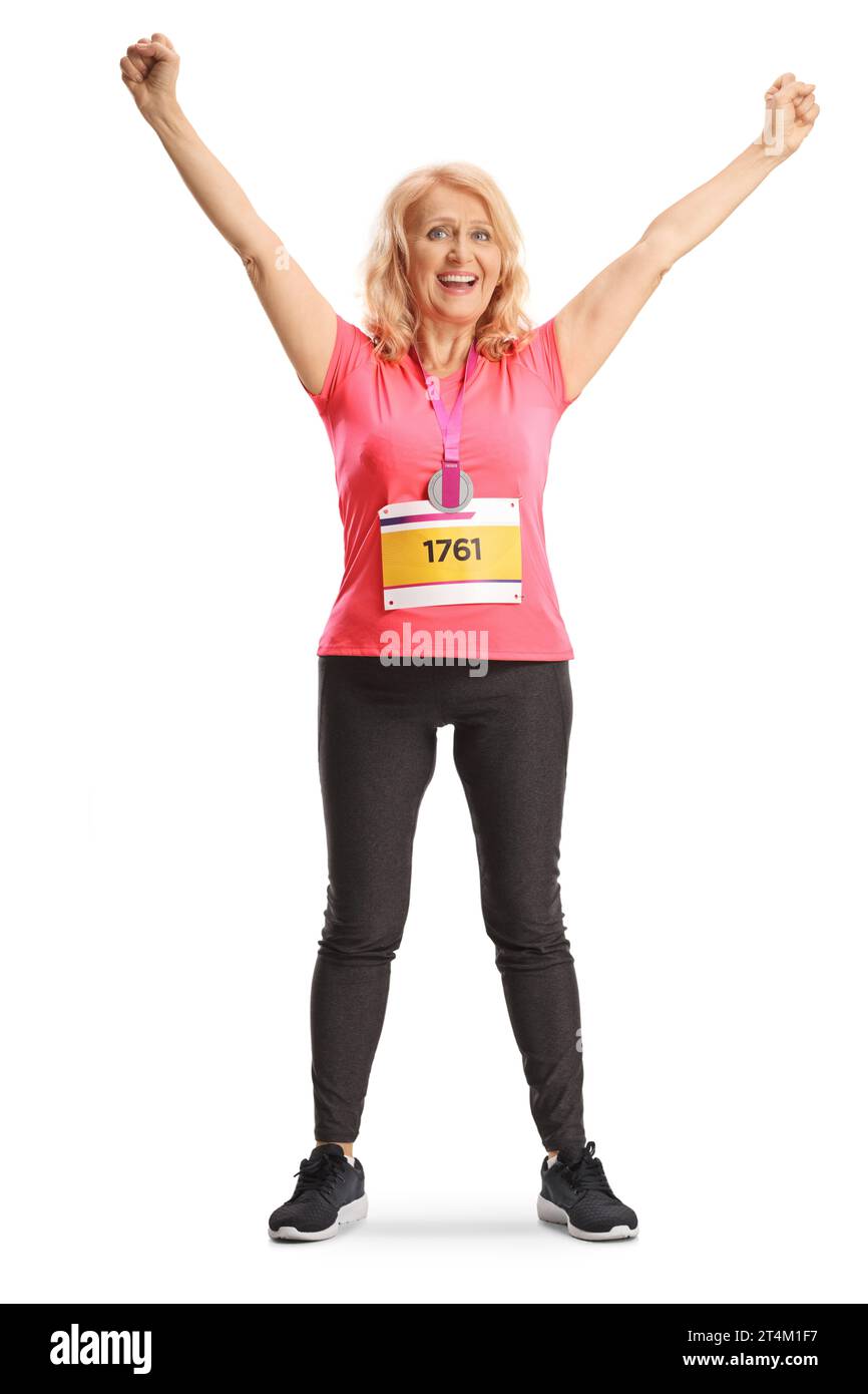 Full length portrait of a happy female marathon runner with a race bib and a medal isolated on white background Stock Photo