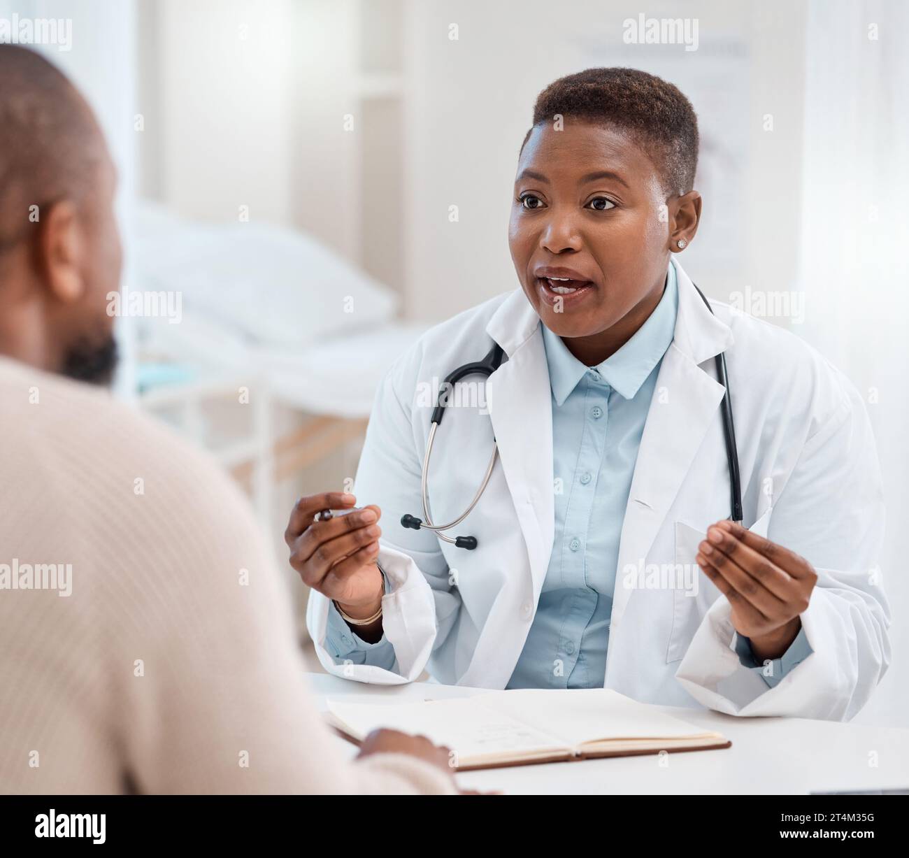 Doctor patient consultation desk candid hi-res stock photography and ...