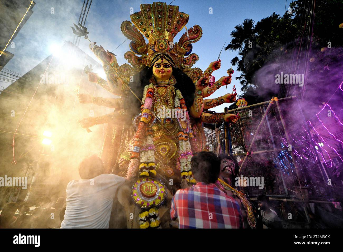 Hindu devotees seen preparing for the immersion procession at Bagbazar. Durga Puja, an annual festival that marks victory of good over evil is celebrated by Hindus all over India & abroad. It is an occasion of great enthusiasm and festivity for the Hindus. On the last day, the day of Bhashan or Vijoya Dashami images and idols are immersed in water. Stock Photo